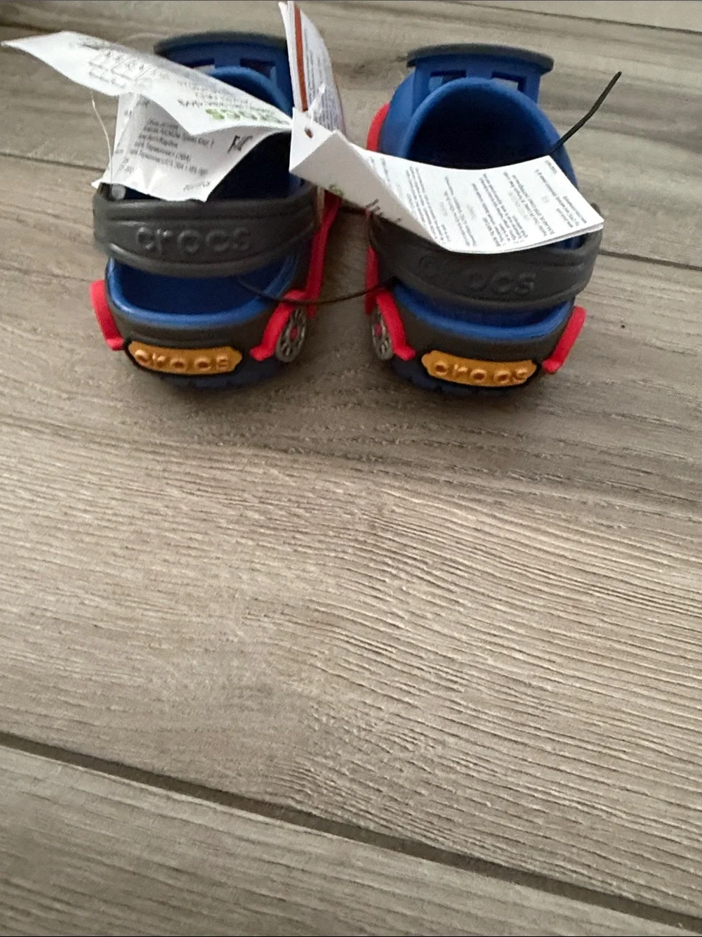CROCS Kids Clog in Blue with Red Trim and Black Badges